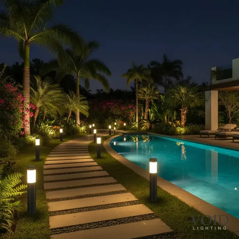 Resort pool walkway lit by solar lights at night