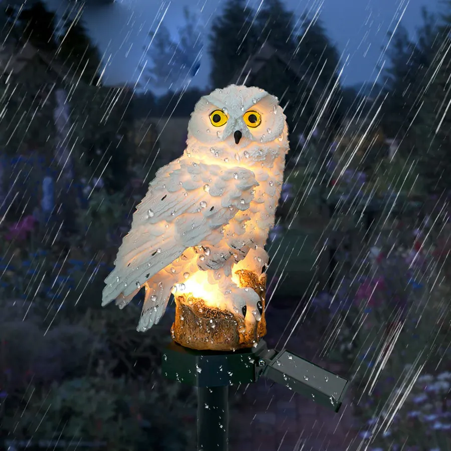 Guardian owl solar resin light glowing in the rain - IP65 waterproof